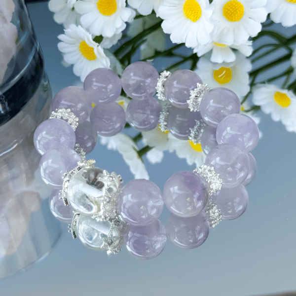 Lavender Amethyst Crystal Bead Bracelet on Reflective Surface
