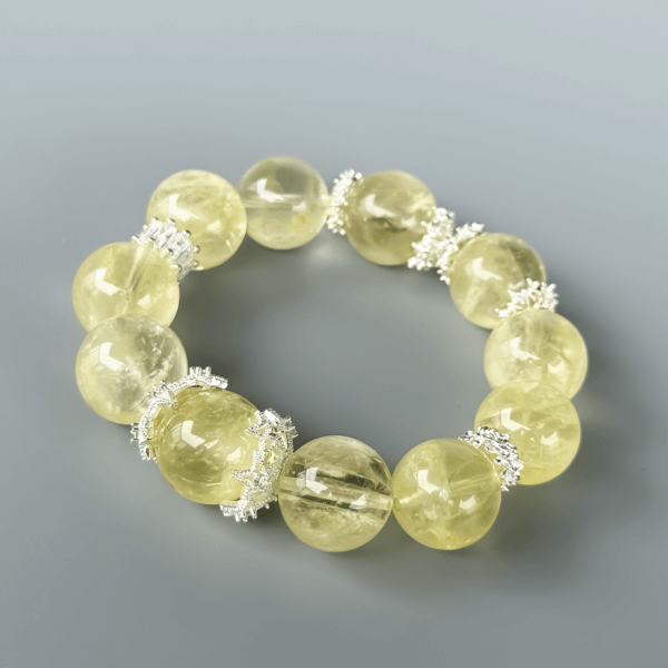 Round Yellow Azeztulite crystal bead bracelet on grey background