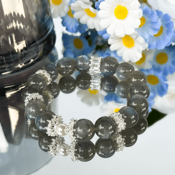 Labradorite beaded bracelet displayed with floral background.