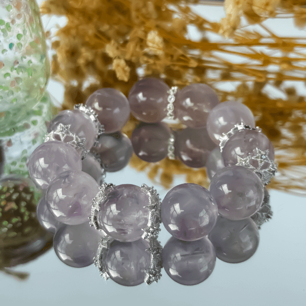 Lavender Amethyst Crystal Bracelet displayed on reflective surface