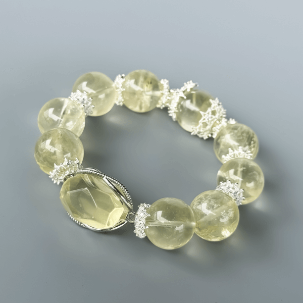 Yellow Azeztulite crystal bead bracelet on a gray background