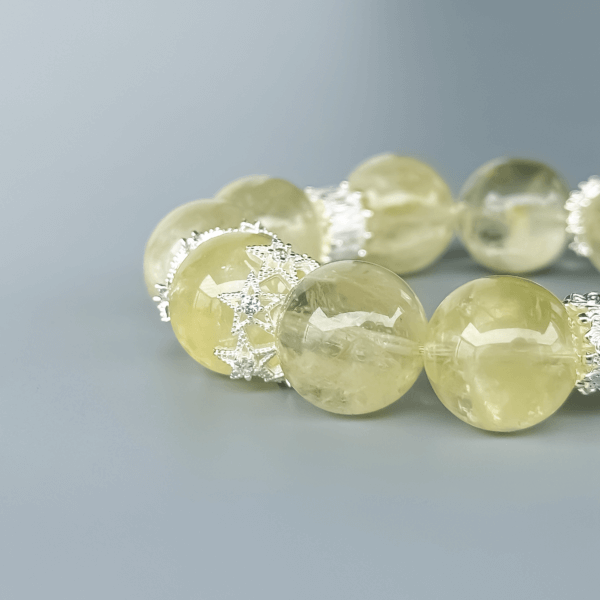 Round Yellow Azeztulite crystal bead bracelet on grey background