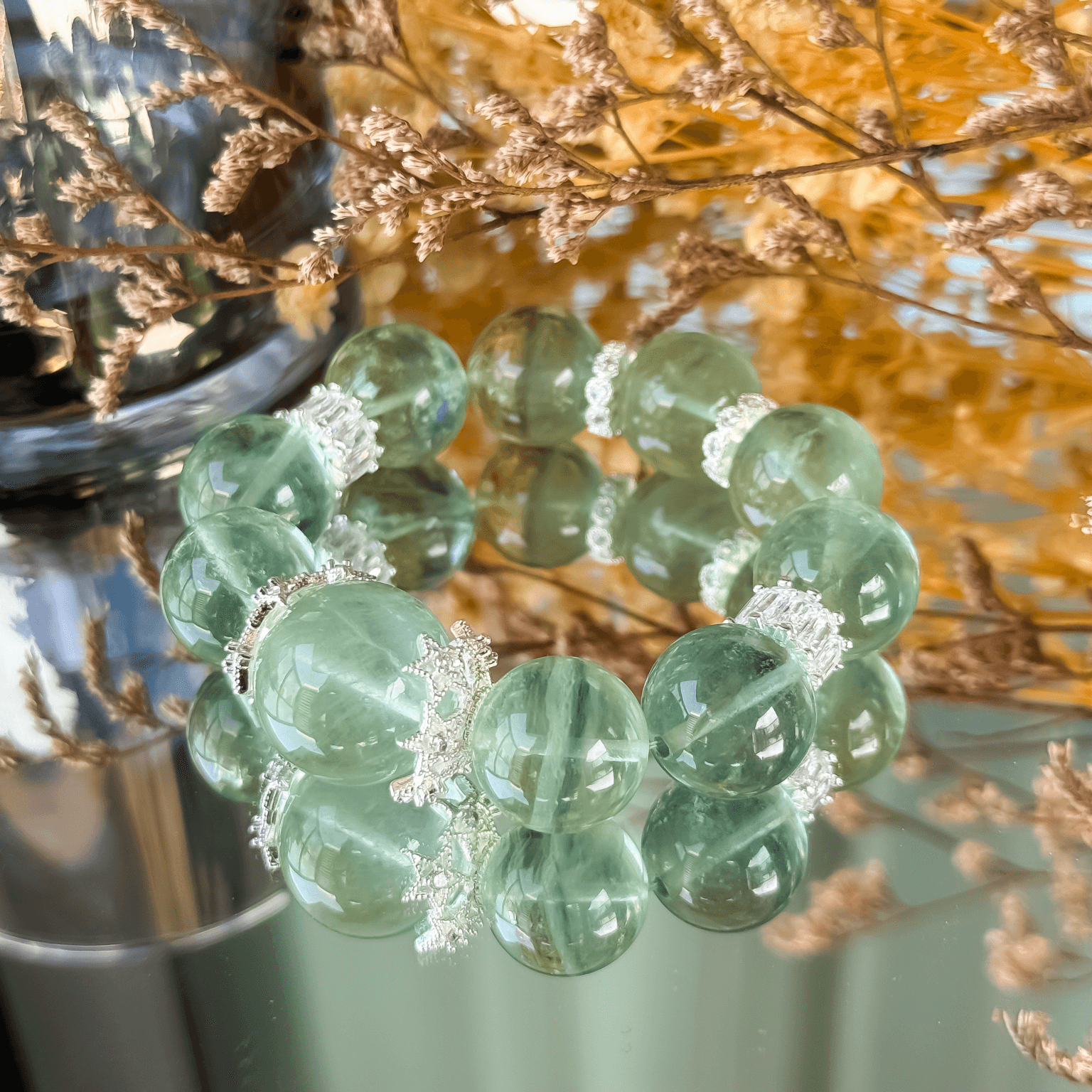 Green Fluorite Bracelet with Silver Spacers Displayed on Glass