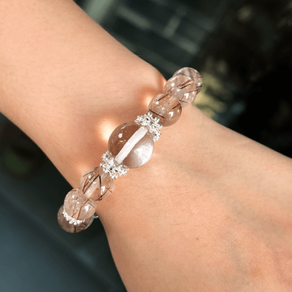 Crystal bracelet with golden rutilated quartz beads on wrist