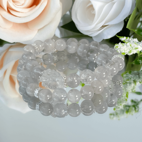 Rose-colored crystal bracelet on reflective surface