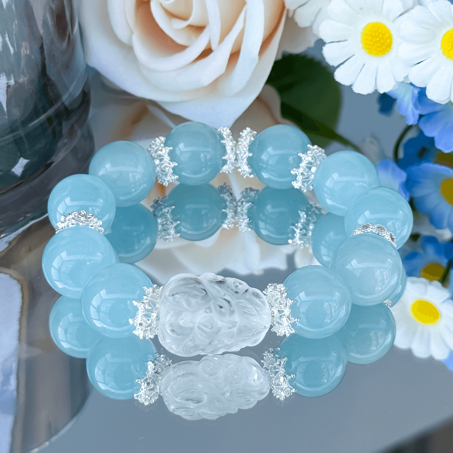 Aquamarine gemstone bracelet with floral silver spacers.