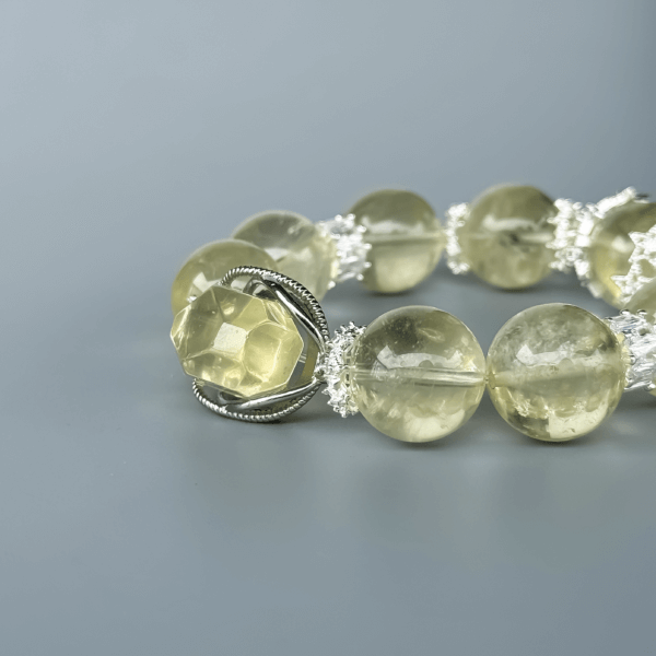 Yellow Azeztulite crystal bead bracelet on a gray background