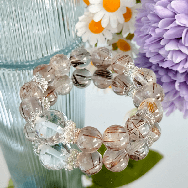 Golden Rutilated Quartz bracelets displayed with floral decor