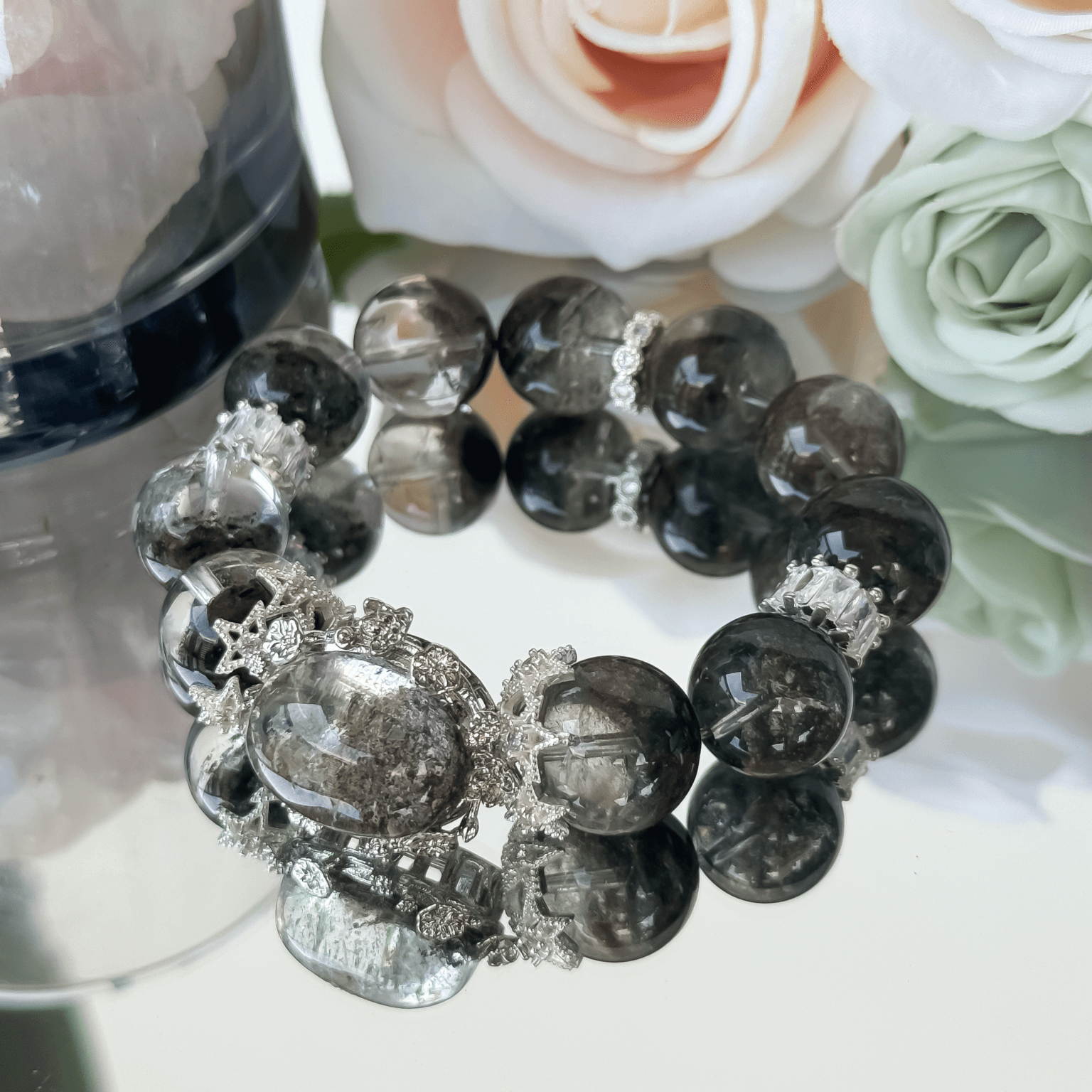 Green Ghost Phantom crystal bead bracelet displayed with roses and silver embellishments