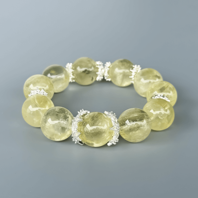 Round Yellow Azeztulite crystal bead bracelet on grey background
