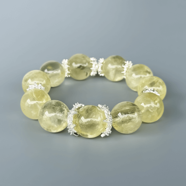 Round Yellow Azeztulite crystal bead bracelet on grey background