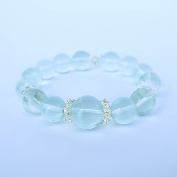 Green Fluorite bead bracelet on white background for product display.