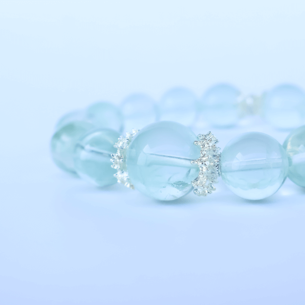 Green Fluorite bead bracelet on white background for product display.