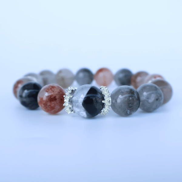 Crystal bead bracelet with gemstone detail on a reflective surface