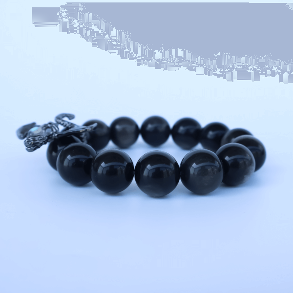 Obsidian bead bracelet with dragon charm on display
