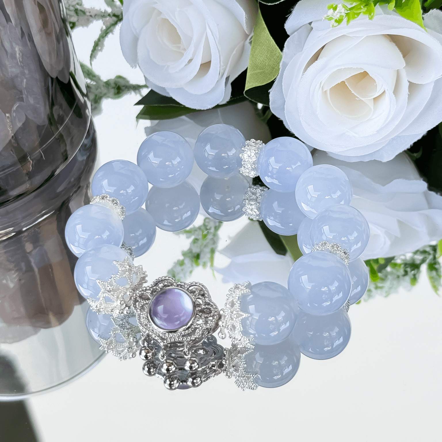Blue Chalcedony crystal bead bracelet with a purple pendant and silver floral spacers