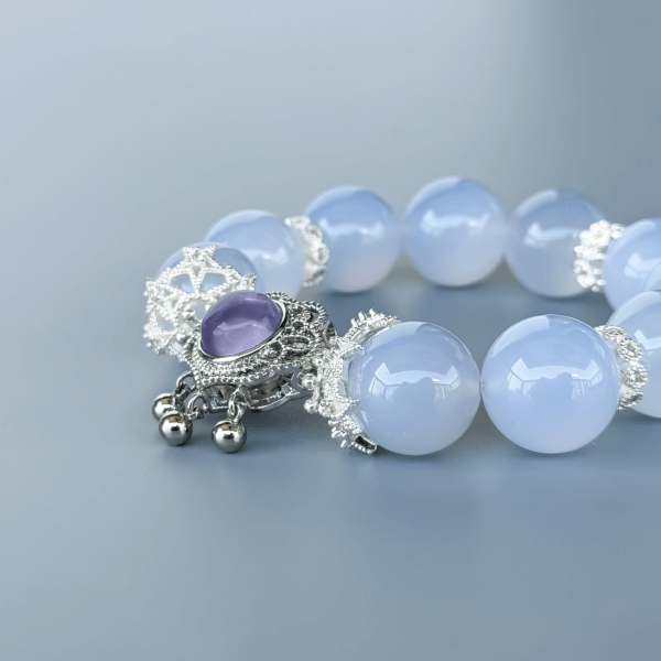 Blue Chalcedony crystal bracelet with a purple pendant and silver spacers