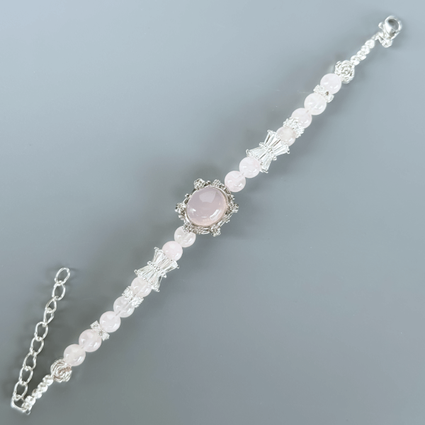 Close-up of Grapefruit Rose Quartz Bracelet with Silver Detailing