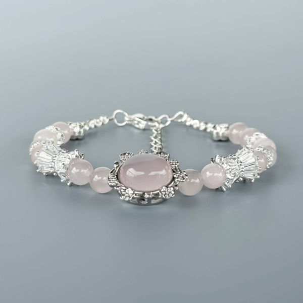 Close-up of Grapefruit Rose Quartz Bracelet with Silver Detailing
