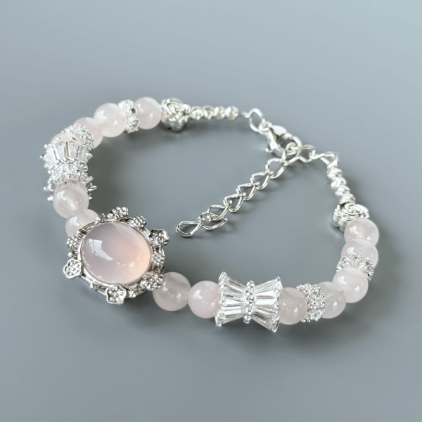 Close-up of Grapefruit Rose Quartz Bracelet with Silver Detailing
