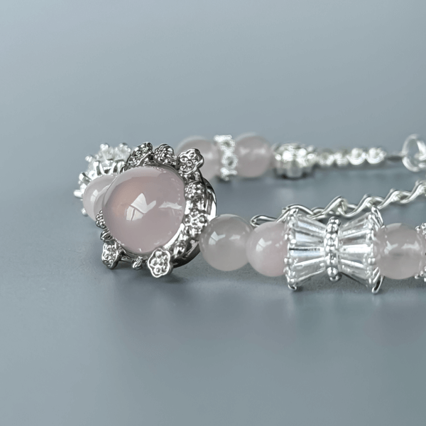 Close-up of Grapefruit Rose Quartz Bracelet with Silver Detailing