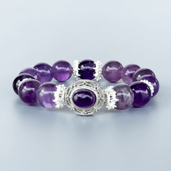 Icy Amethyst crystal bead bracelet with silver detailing on a neutral background