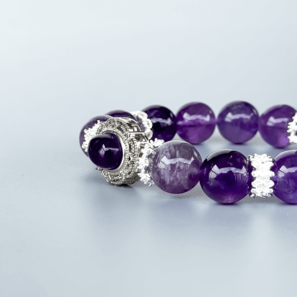Icy Amethyst crystal bead bracelet with silver detailing on a neutral background