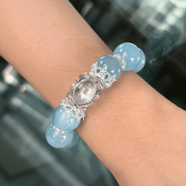 Aquamarine Crystal Bead Bracelet on Wrist Displaying Blue and Silver Details