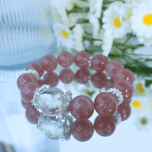 Strawberry Quartz bracelet reflecting in a mirror with floral background