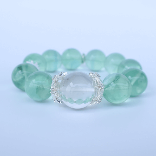 Green Fluorite Bead Bracelet with Clear Center Bead on White Background