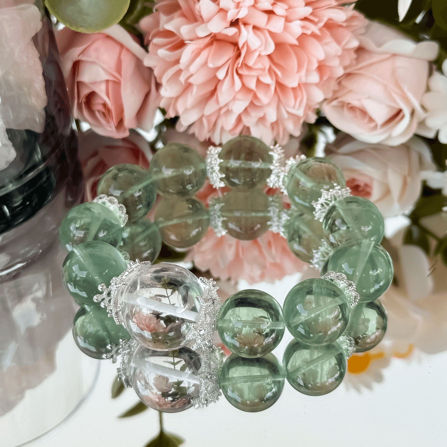 Green Fluorite Bracelet with pink flower background