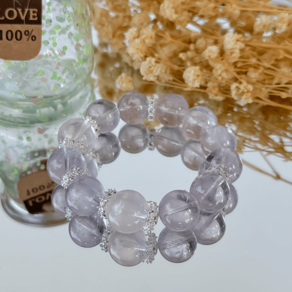 Purple Rabbit Hair Crystal Bead Bracelet with decorative background