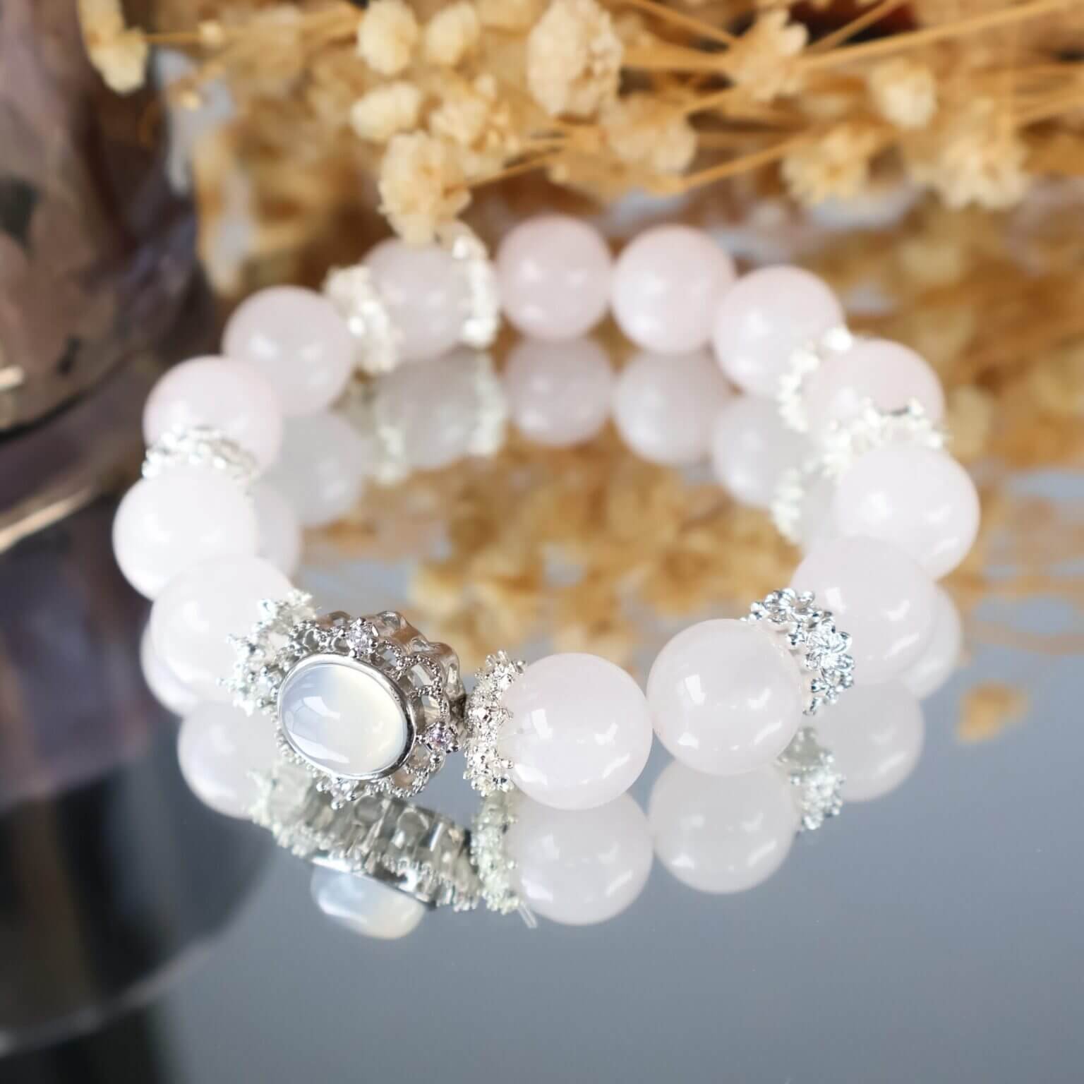 Elegant pink crystal bracelet with silver accents and a luminous crown centerpiece