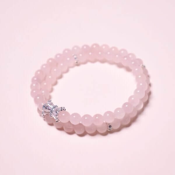 Rose quartz bracelet with double-strand layout on white background