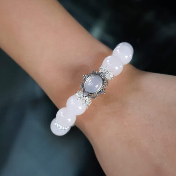 Starry Blush bracelet with pink crystal beads and silver crown centerpiece on wrist
