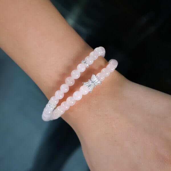 Rose quartz bracelet on wrist with silver accents
