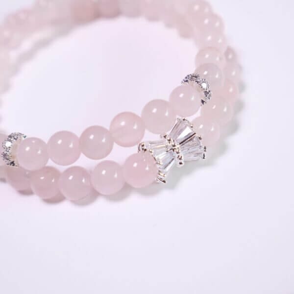 Rose quartz bracelet with double-strand layout on white background