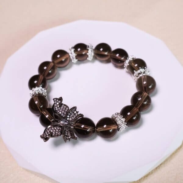 Smoky quartz bracelet featuring butterfly centerpiece and silver accents
