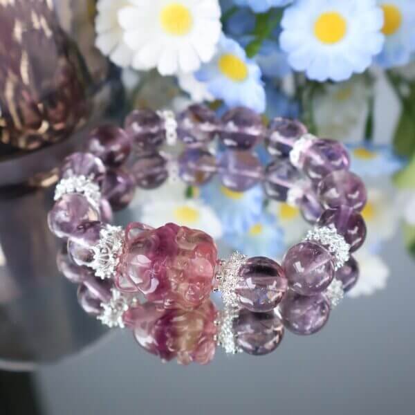 Purple crystal bracelet worn on wrist, showcasing elegant design.