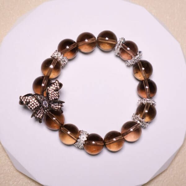 Smoky quartz bracelet featuring butterfly centerpiece and silver accents