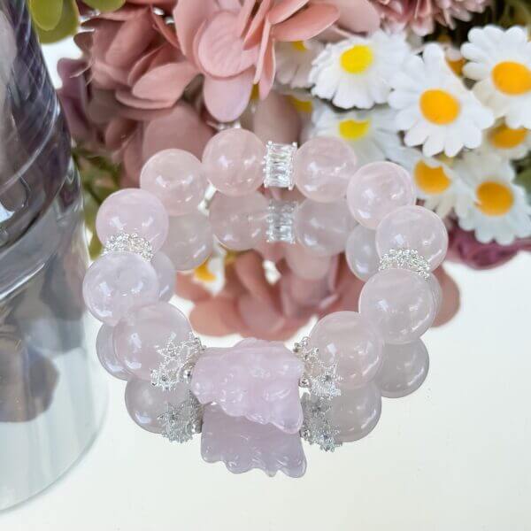 Rose quartz crystal bracelet with floral background