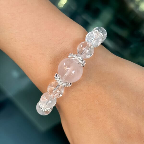 Rose quartz crystal bracelet on wrist with silver details