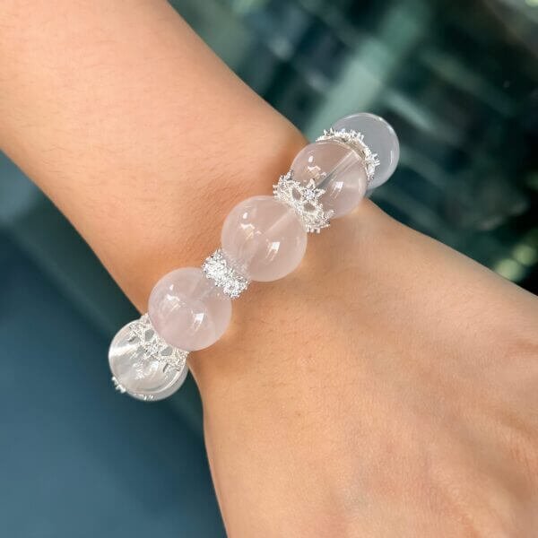 Milk white crystal bead bracelet worn on wrist with silver accents