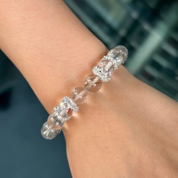 Green Rutilated Crystal bracelet on wrist with silver accents